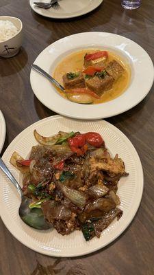 Drunken noodles and panang tofu curry in the back