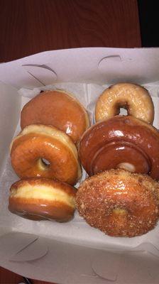 Raspberry jelly filled donut, regular glazed donut, maple glazed donut, blueberry cake donut, cinnamon roll donut, and cinnamon cake donut.