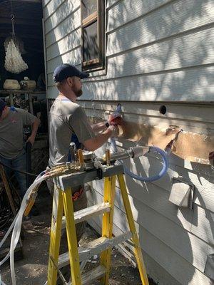 Injecting foam into  vinyl exterior home