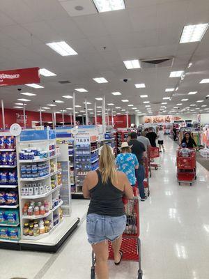 A long line of people waiting for self checkout and only ONE register is open.