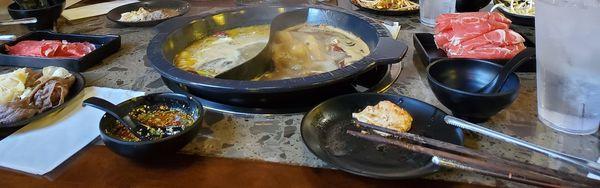 Split bowl with chicken base on keft and spicy beef on the right. Spicy dipping sauce that the staff made for us. Meats and veggies.