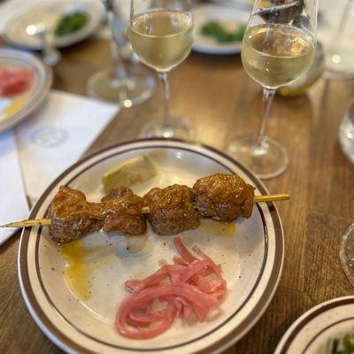 Tapas: Pinchos Morunos: pork marinated in olive oil and spices, pickled onion, paired with La Ina Fino Sherry from Andalucia