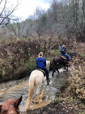 Riding through a river.