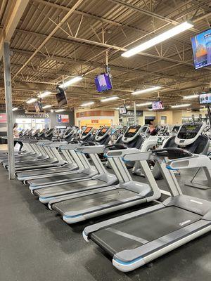 Treadmills, some with orange signs showing 'out of service'