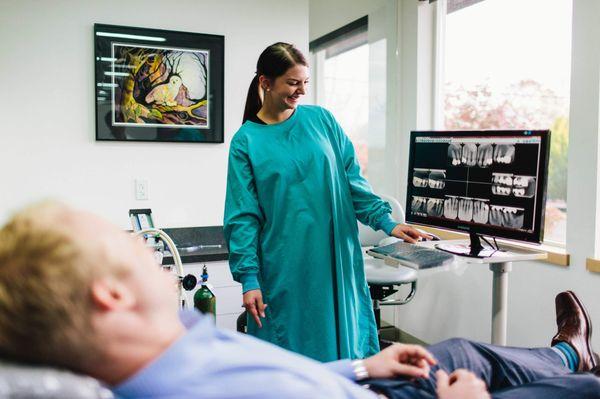 Dental crown and root canal patient viewing his x-ray images at Oregon City dentist Beavercreek Dental