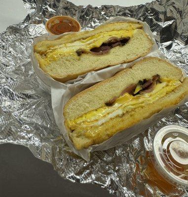 Bacon, egg, and cheese sandwich with sauce on the side (hot honey and house made hot sauce).