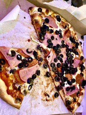 Pepperoni Pizza with added ham and olives.