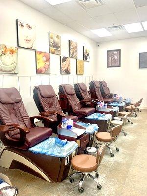 View of the pedicure chairs bagged with liners for sanitation. 
This section is usually occupied.