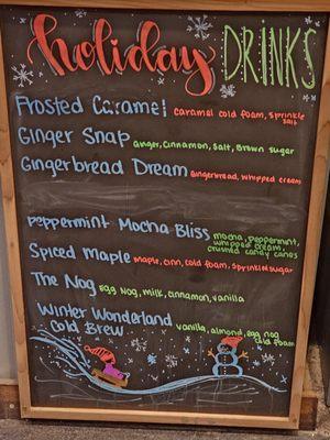 A blackboard with the Holiday Drinks written with color chalk.