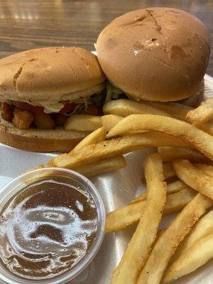 Shrimp Po-boy with French fries and a side of gravy.