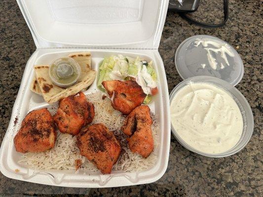 Chicken Sheesh Kabob over Rice and served with pita bread and salad. Don't miss the Tziki Sauce , it is amazing!