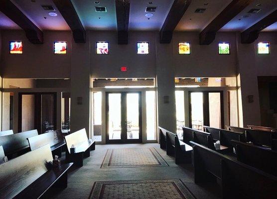 The Chapel filled with natural light and colorful reflections from the stained glass windows.