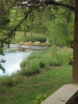 view off cabin 9 porch. Kids playing just above the Cypress Water Fall