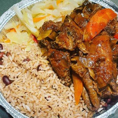 Brown chicken platter with rice and cabbage. Not seen but part of it is tostones and bread.