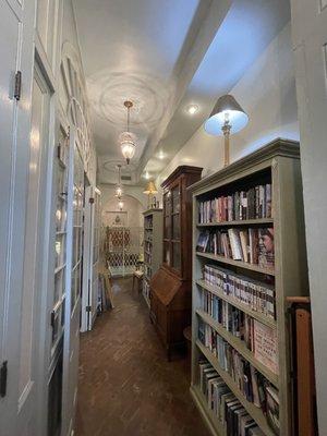 Hall outside the main floor of the bookstore.  Shelves of books  in this area as well.