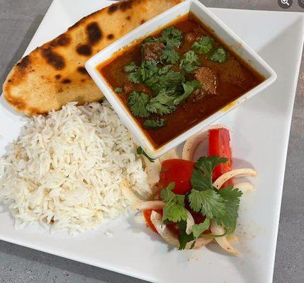 Beef Vindaloo with Basmati Rice, Naan, and Kachumber.