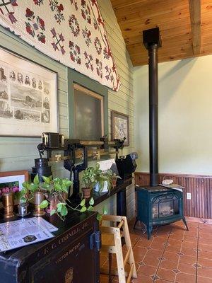 Cozy interior with quilt, vintage Cornell safe and stovepipe.