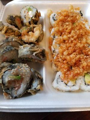 Two different types of sushi, one with tempura friend and another with crunch on top.