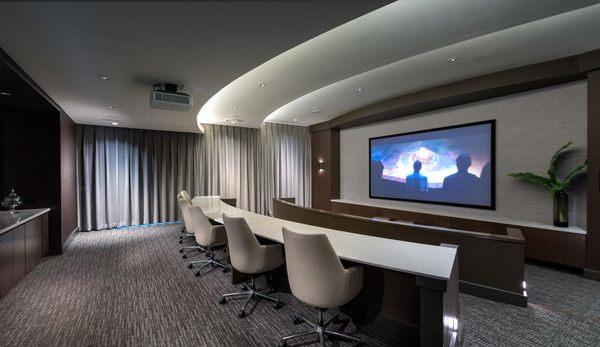 Private media and screening room featuring surround-sound and stadium seating