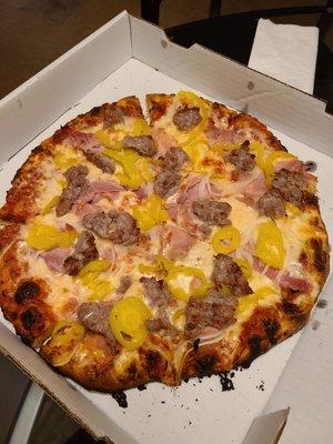 Sausage, ham, onion, and banana pepper pizza