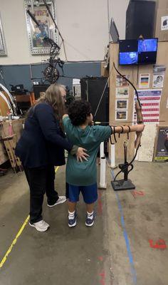 Theresa (proprietor) teaching my nephew how to use a bow for he first time!