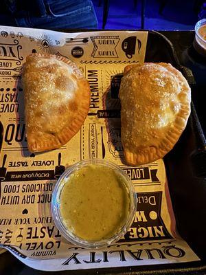 Chicken and cheese empanada and spicy beef empanada with sauce