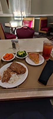 Country style steak with white rice, glazed carrots, broccoli with cheese, coconut pie, and sweet tea.