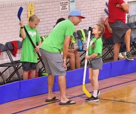 Our coaches teaching the game of hockey.