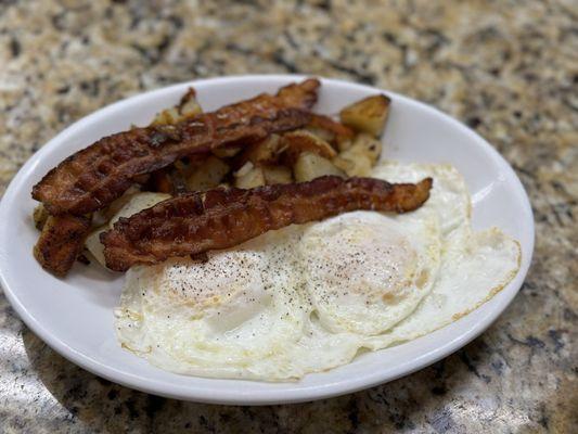 Eggs over easy with breakfast potatoes and crispy bacon (I requested)