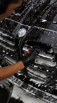 Cleaning all crevices thoroughly before applying a ceramic coating, ensuring every inch of your vehicle is spotless for optimal protection.