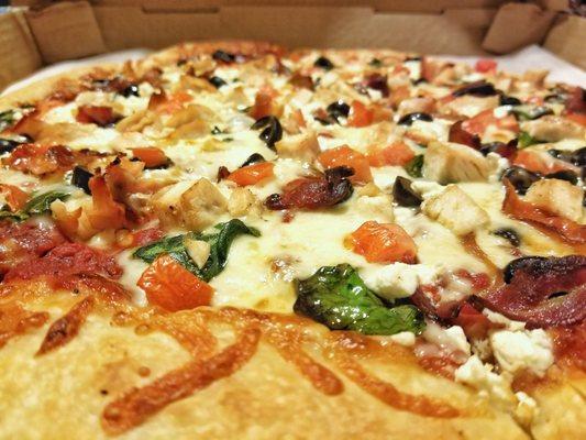 Grecian Pizza with added Grilled Chicken and Bacon.