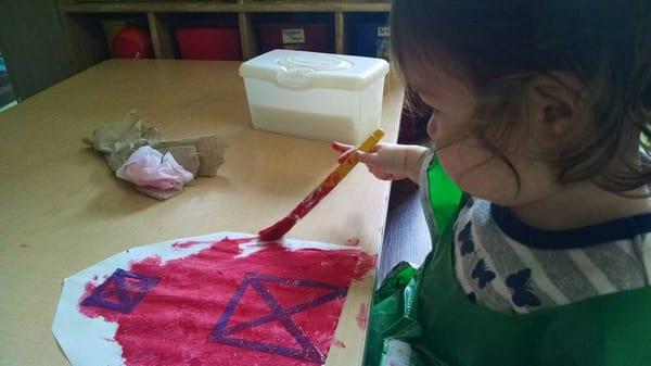 My daughter painting a barn (the theme of the month is farm life) in her classroom :)