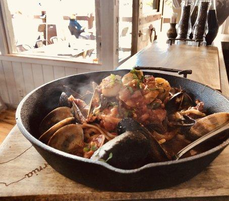 Cast Iron Seafood Pasta Special.  Wild caught Salmon, Gulf Prawns, Monterey Calamari, Clams, Mussels