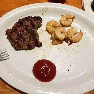 This is what I got for surf and turf. Pathetic. steak over cooked and dried out and shrimp under cooked too. I'd be ashamed to serve this.