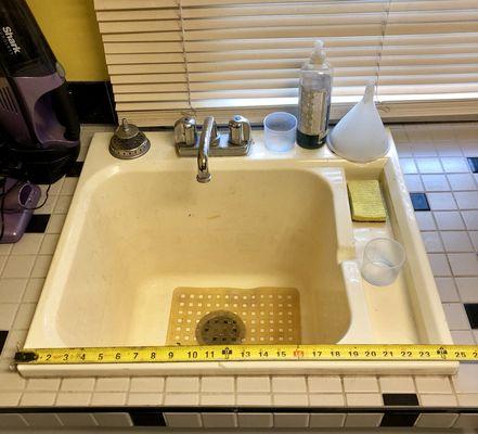 Removed an old discolored plastic laundry tub for a new Kohler cast iron sink.