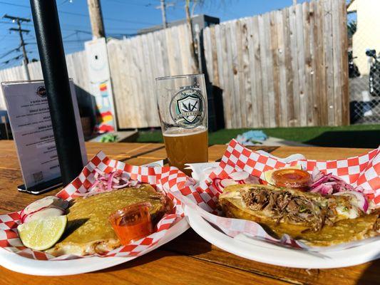 Hefeweizen beer with the taco caterers. Love the outdoor seating here. Tasty beer and very cheesy birria tacos.