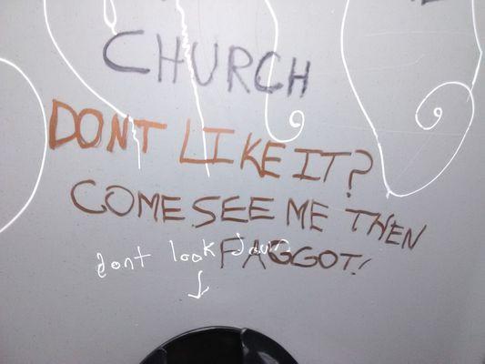 bias/hate graffiti in restroom setup for BottleDrop in the parking lot