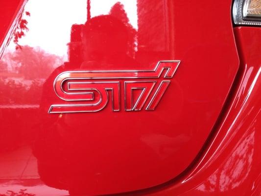 STI - Logo for the performance division of Subaru (Subaru Techinca International) on the back of a 2015 WRX STI in the showroom