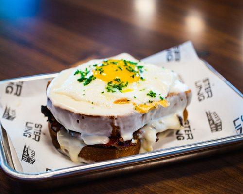 Breakfast Sandwich [maple sage sausage, sunny side up egg, chili mayo, caramelized onions, cheddar cheese, milk bun]