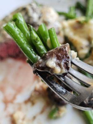 A fork with The Filet Mignon main entrée.