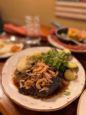 BISON POT ROAST North Dakota bison with blueberry- lavender demi-glaze, seasonal vegetables, Yukon gold mashed potatoes & crispy onions.