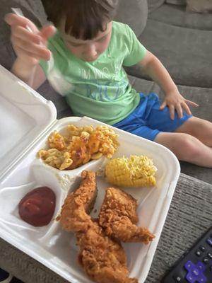 Chicken Tenders Plate with Mac and Cheese and half of his Corn on the Cob