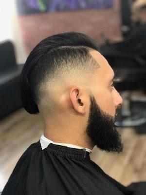 Fade with beard contrasted to perfection with styled combover on top.