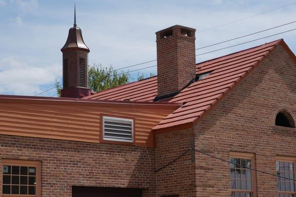 Commercial roof replacement- Ludowici clay tile - English flat tile - red clay reclaimed from existing building and new tile....