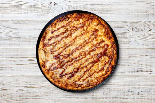 Savor the perfect blend of tangy BBQ sauce, grilled chicken, and melty mozzarella on our BBQ Chicken Pizza. It's a mouthwatering delight tha