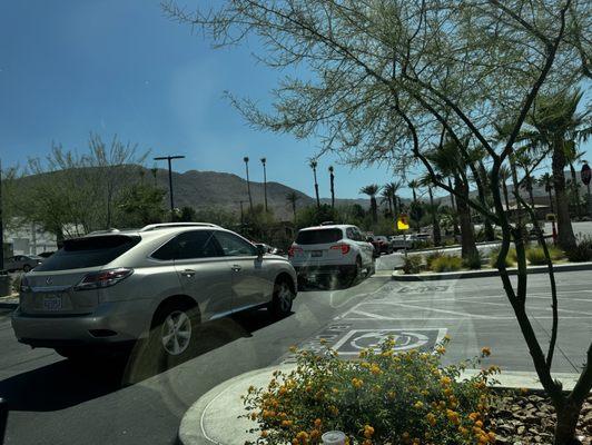 Steady stream of In & Out burger line of cars just INCHES from the nose of my vehicle ....