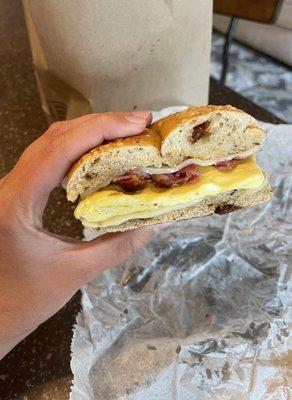 Tomato Bagel with egg, bacon, and Swiss cheese.