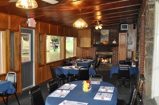 Dining Room with fireplace and access to outdoor dining pavilion.