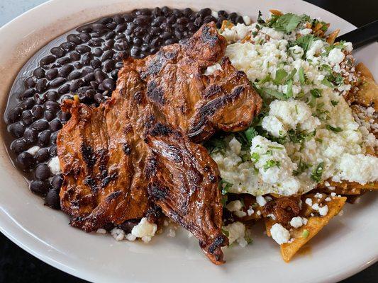 Chilaquiles with carne asada! Delicious and tender meets crispy and saucy! Get it with the carne asada! (steak)