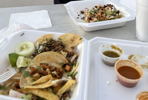 Assorted tacos and Asada Fries with horchata